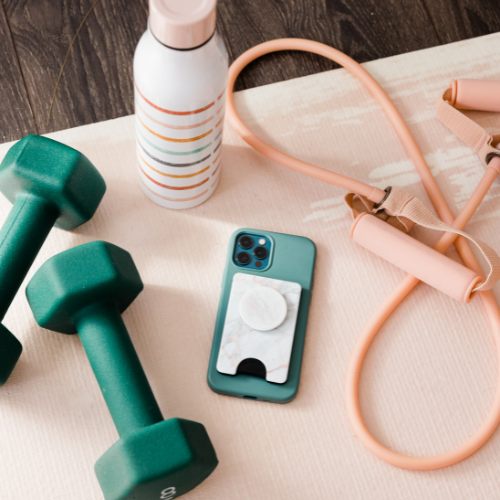 a skipping rope, weights, mobile phone and bottle of water for a training session